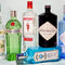 Collection of gin bottles including Tanqueray, Beefeater, Hendrick's, and Bombay Sapphire on a light background.